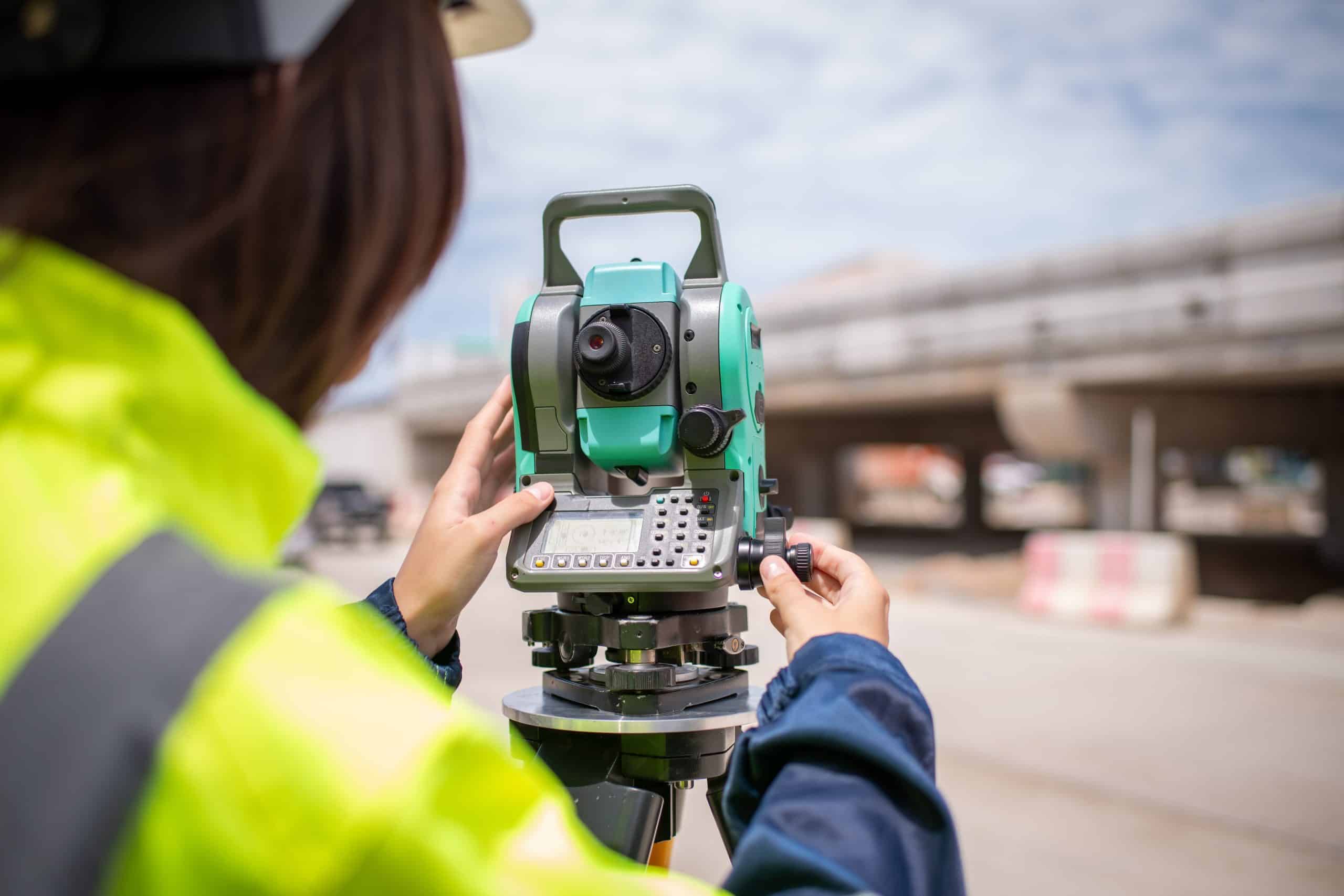 a person using a theodolite